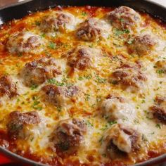 a pizza with meatballs and cheese in a pan