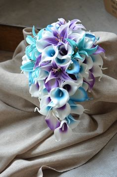 a bridal bouquet with purple and blue flowers