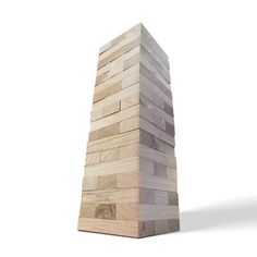 a large wooden block tower sitting on top of a white floor next to a wall