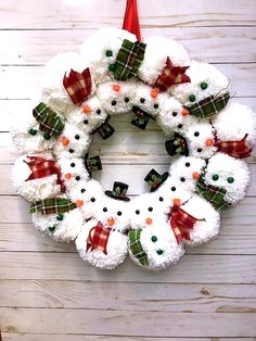 a snowman wreath hanging on the wall