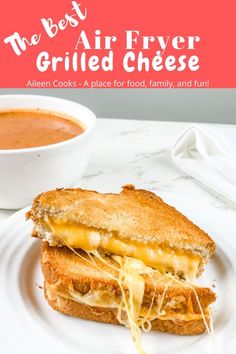 a grilled cheese sandwich on a white plate next to a bowl of tomato soup