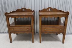 two wooden nightstands side by side against a wall