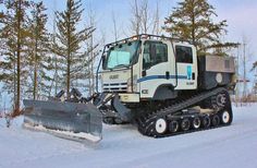 a snow plow is parked in the snow