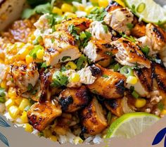 a bowl filled with chicken, corn and rice