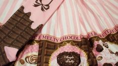 a pink and brown umbrella with chocolate decorations on it