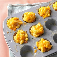 muffin tins filled with eggs sitting on top of a table