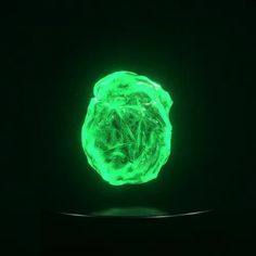 a glowing green object in the dark