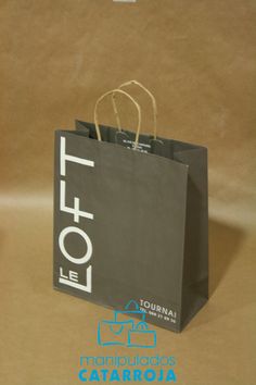 a black shopping bag sitting on top of a brown paper bag with the word tofte printed on it