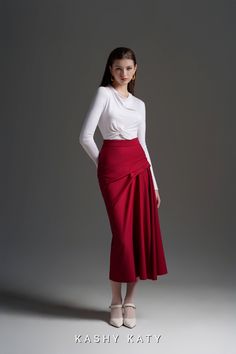 "The Jonette Draped Skirt is the epitome of elegance and sophistication. This mid-length skirt features exquisite pleated draped details on the left side, adding a touch of artistry to your ensemble. With a little high-waisted design, this skirt exudes a formal and academic vibe, perfect for various occasions. The closed-fit effect around the seat and thigh creates a flattering silhouette. Crafted from high-quality Ponte de Rome, this skirt has a buttery soft, suede-like feel. Pair it with the Y Elegant Pleated Mini Wrap Skirt, Elegant Long Red Pencil Skirt, Elegant Red Long Pencil Skirt, Fitted Midi Draped Skirt With Gathered Detail, Formal Pencil Wrap Skirt With Lining, Elegant Red Asymmetrical Skirt, Elegant Red Gathered Skirt, Elegant Fitted Red Wrap Skirt, Elegant Red Fitted Wrap Skirt