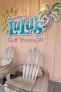 two wooden chairs sitting next to each other in front of a sign that says lilly's gulf shores, al