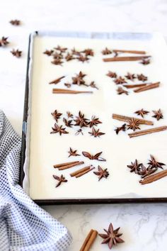 an image of cinnamon sticks and star anise on a sheet of white icing