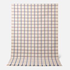 a beige and blue checkered blanket on a white background