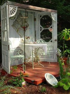 an outdoor table and chairs are set up on the deck in front of a gazebo