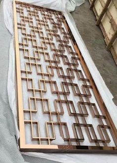 a large metal grate sitting on top of a sheet of white paper next to boxes