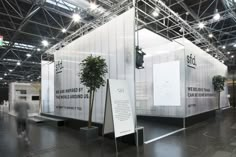 an exhibit room with white walls and black flooring