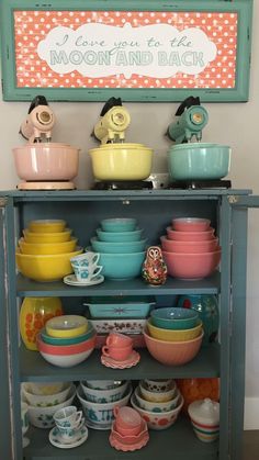 a shelf filled with lots of different colored bowls and plates on top of each other