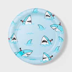 a blue paper plate with sharks on it