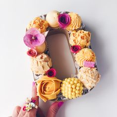 the letter d is made out of cupcakes and other pastries with flowers on them