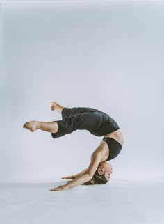 a man is doing a handstand on the floor