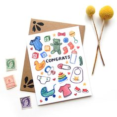 a card with some stamps on it next to two yellow balls and one green ball