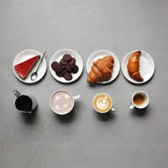 there are many different types of breakfast foods on the table, including coffee and croissants