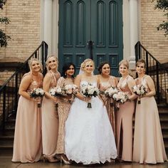 a group of women standing next to each other in front of a door holding bouquets