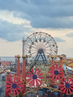 an amusement park with ferris wheel and other rides