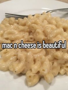 mac n cheese is beautiful on a white plate with a fork and some type of food