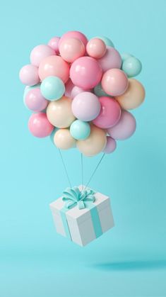 a bunch of balloons floating in the air with a gift box attached to one of them