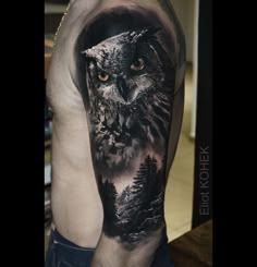 an owl tattoo on the arm and shoulder