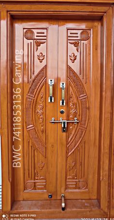 a wooden door with ornate carvings on the front and side panels, as well as metal handles