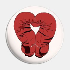 two red boxing gloves on top of each other in the shape of a heart ornament