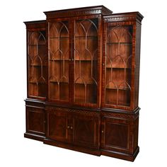 a large wooden bookcase with glass doors on the front and side panels, in dark wood