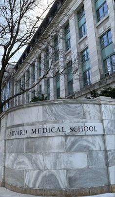 the sign for harvard medical school is shown in front of a building with many windows