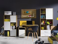 a child's bedroom with yellow and white furniture, bookshelves and toys