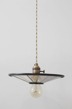 an old fashioned light hanging from a ceiling