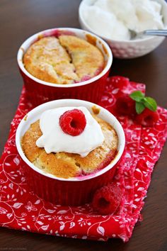 two red cups filled with food on top of a table