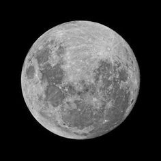 the full moon is shown in black and white