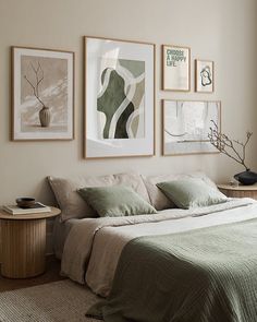 a bed sitting in a bedroom next to two framed pictures on the wall above it