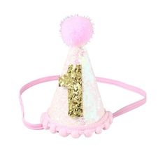 a pink and white hat with gold sequins on it's headband