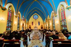 the inside of a church with people sitting in pews