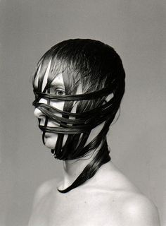 a woman with black hair and strips on her face