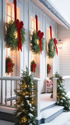 christmas wreaths on the front steps of a house