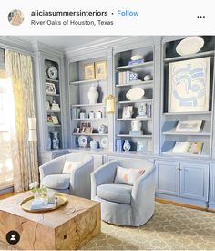 a living room filled with blue furniture and bookshelves