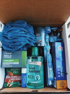 an open box filled with different types of personal care products and hygiene items, including hand sanitizers