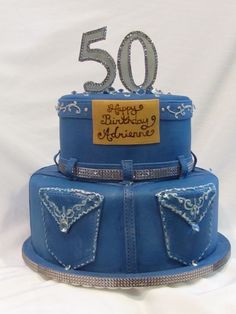 a blue birthday cake with the number 50 on it's top and diamond trimmings