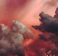 an airplane flying in the sky with clouds