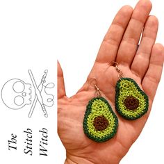 a pair of crocheted earrings with an avocado design