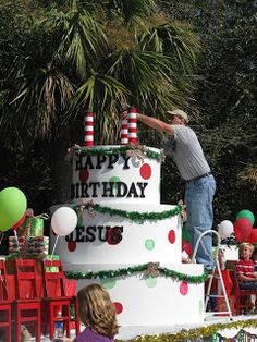 a man standing on top of a giant cake