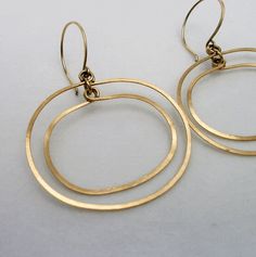 "Gold Oval Double Hoop Earrings ~ A modern retro take on the simple hoop dangle. Beautifully hand crafted of hammered gold fill wire, the two hoops move independently giving a subtle glimmer with every move you make. They are extremely light weight and perfect if you can't wear heavy earrings but like to wear a larger earring.  2\" length including the ear-wire and 1 5/8\" at the widest point. They fall just below the jawbone. Your purchase will arrive beautifully packaged in a floral jewelry bo